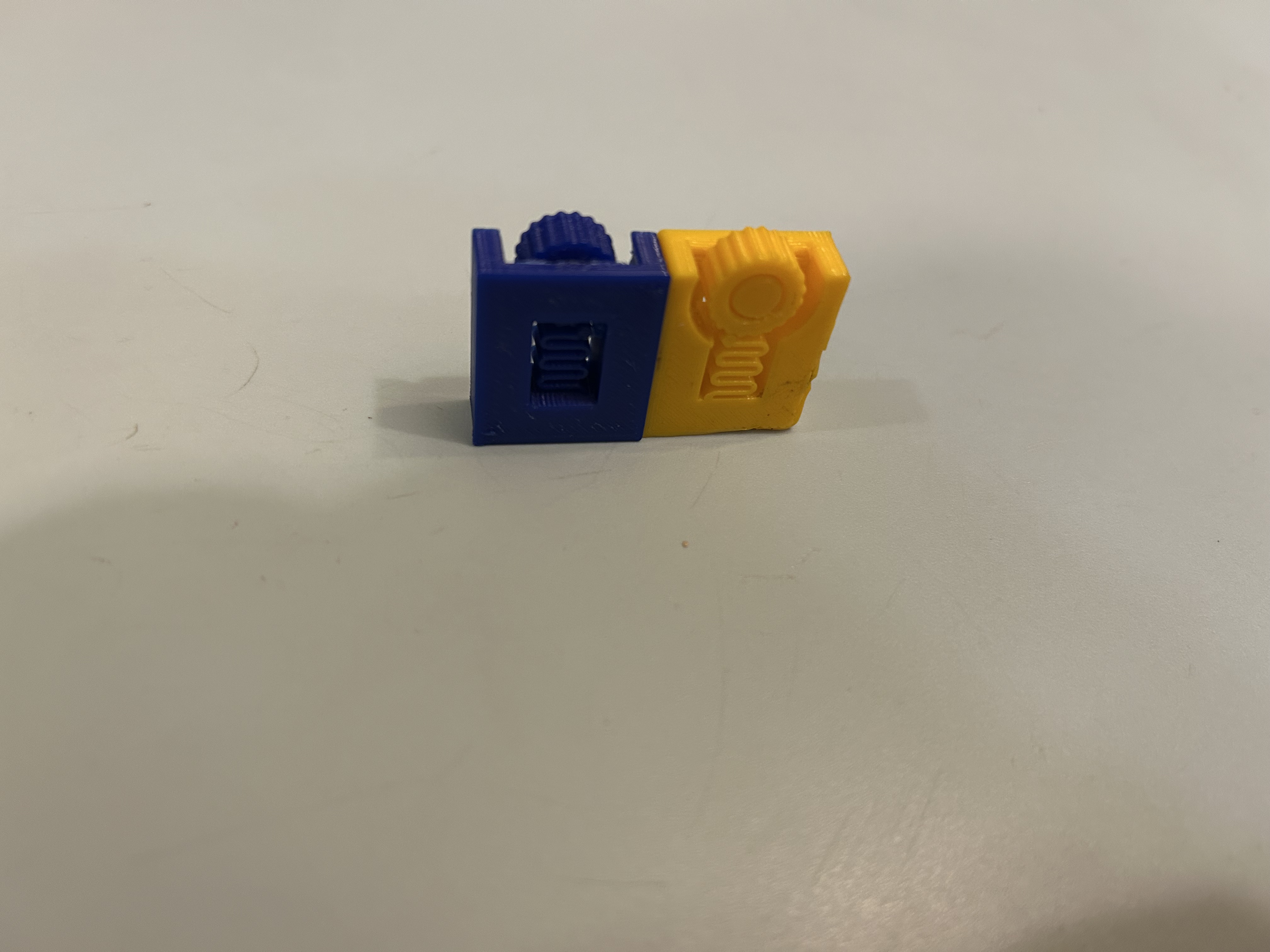 Angled view of the blue and yellow prototypes, showing their gears and frames