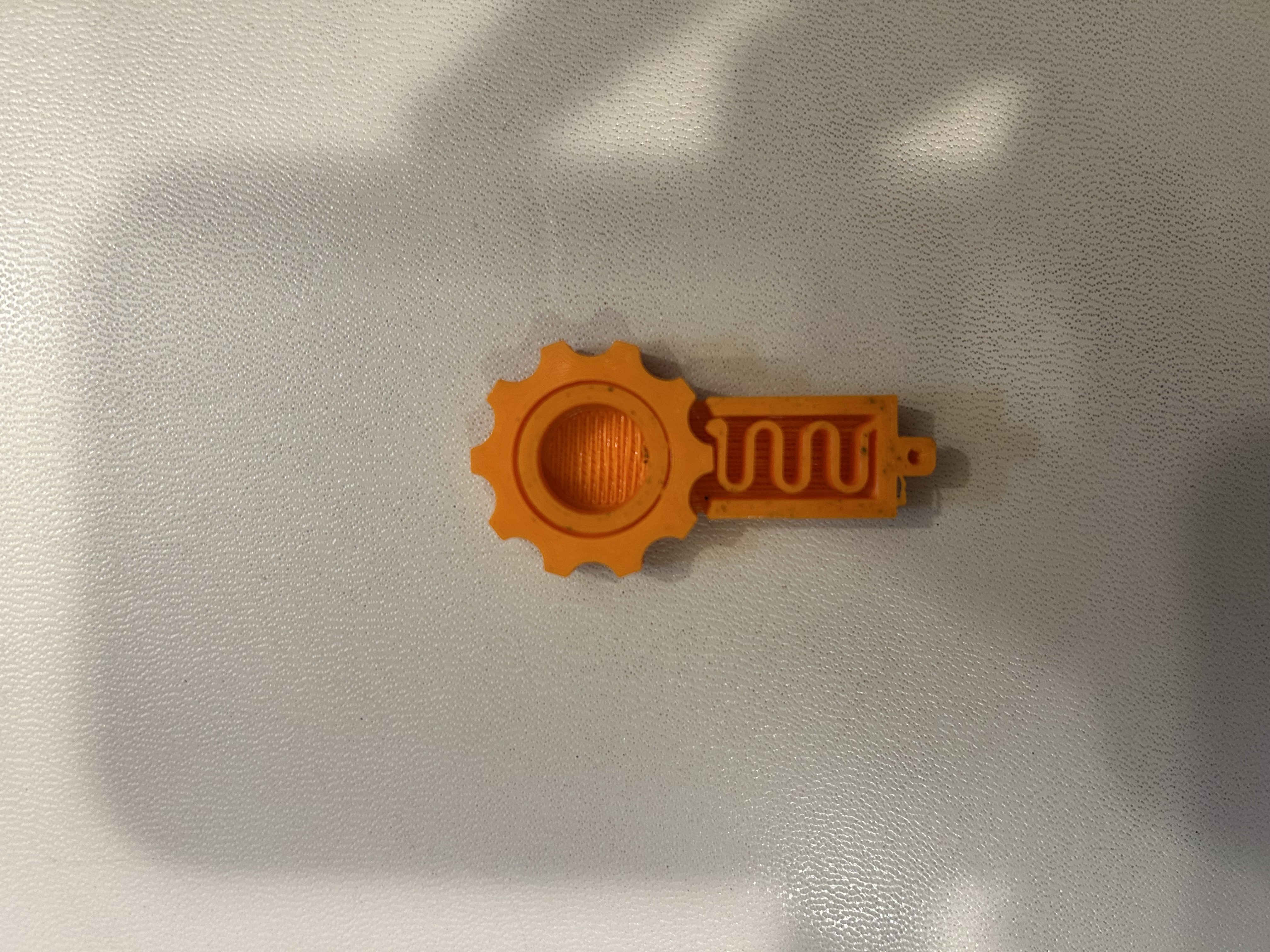 Orange Version 7 prototype with a smaller spring tip beneath the gear